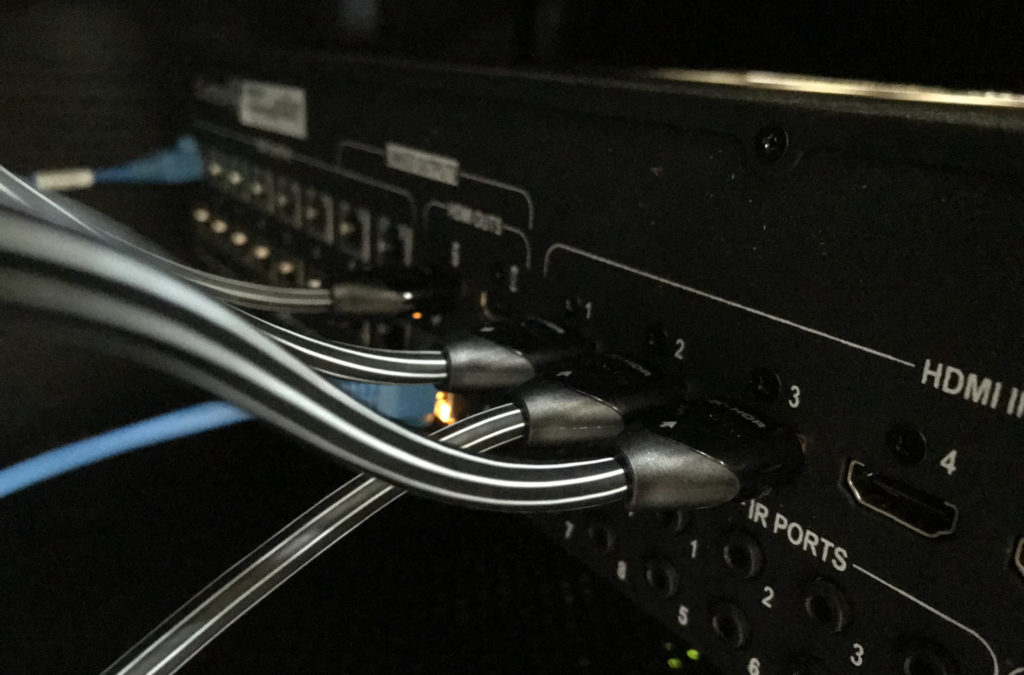 HDMI and network cables connected to the back of a video matrix